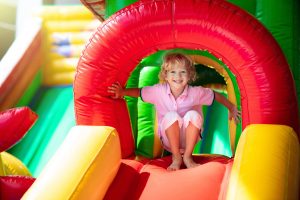 Girl smiling on an inflatable bounce house