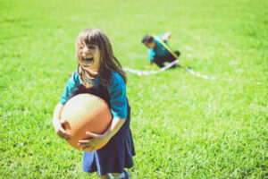girl playing kickball
