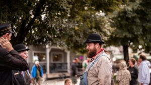 Men in historical clothing gathered outdoors