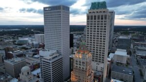 Aerial view of Tulsa cityscape with prominent ONEOK Building at twilight.