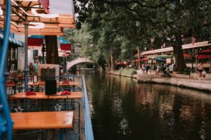 Charming riverside dining scene at San Antonio River Walk with evening ambiance.