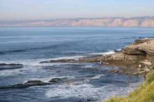 Explore the stunning coastline of La Jolla with ocean waves and rocky shores.