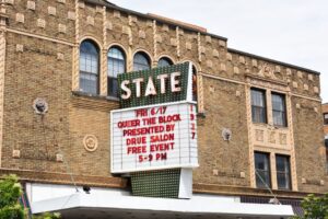State Theatre facade in Kalamazoo with marquee announcing event.