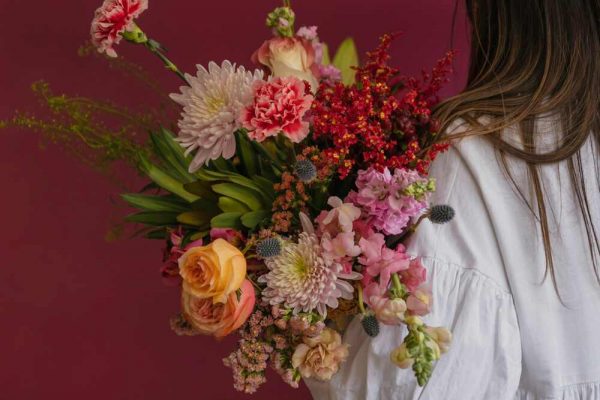 Floral Vendor Holding a Beautiful Bouquet